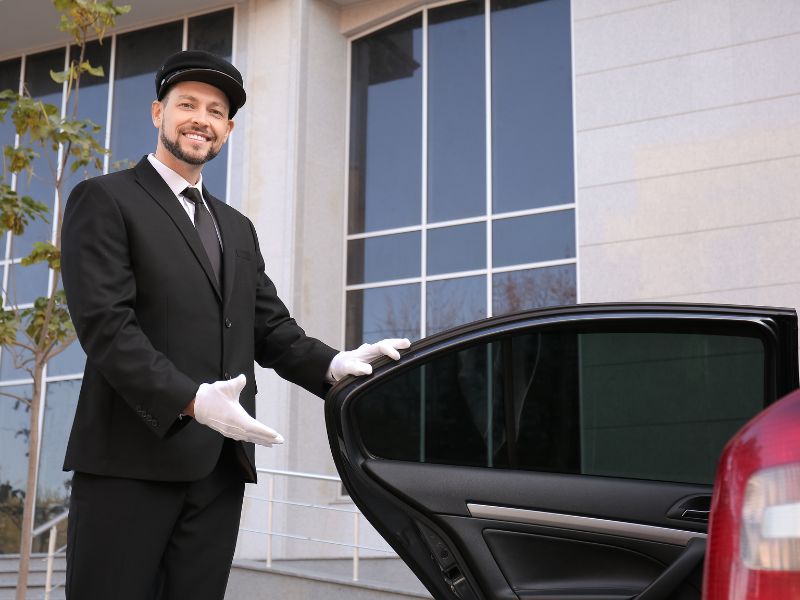 Car service Brooklyn Park with a smiling chauffeur opening the door for a smooth ride.