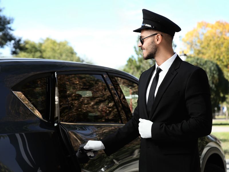 Professional chauffeur in black suit providing premium car service in Rochester MN.